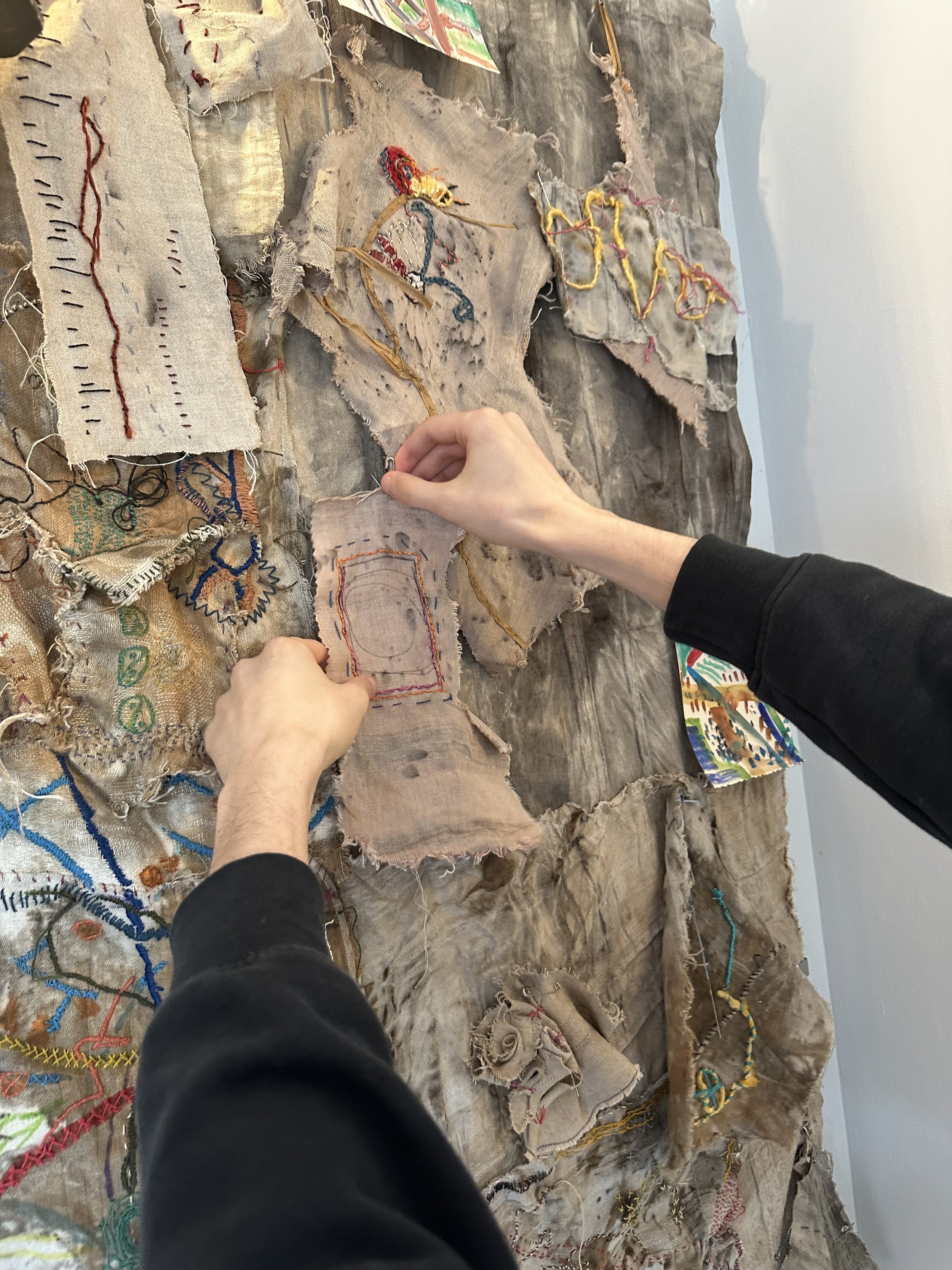 Austen pinning on textile panel.jpeg