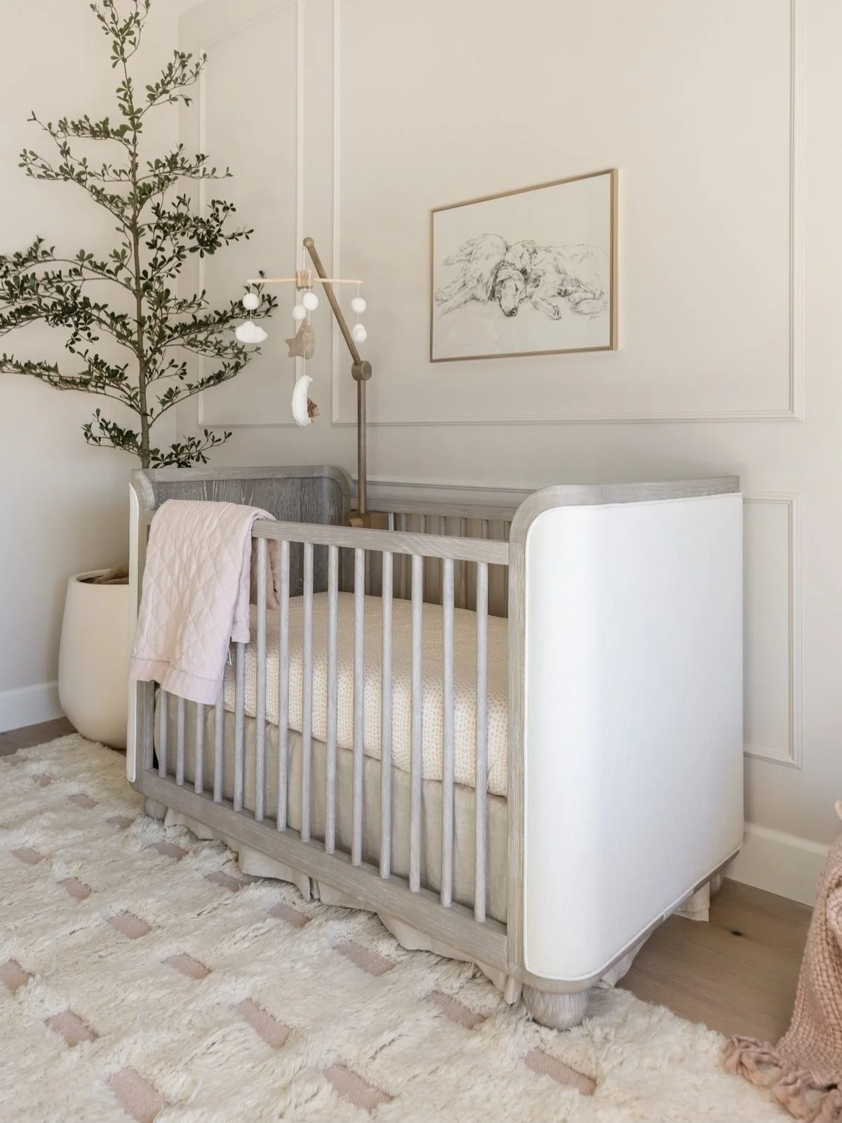 Designed with a muted palette to complement the rest of the home, this nursery introduces a softer, more feminine feel through dusty pink accents, brass finishes, and subtle bow details. Gentle curves and quiet nods to our client&rsquo;s golden retri