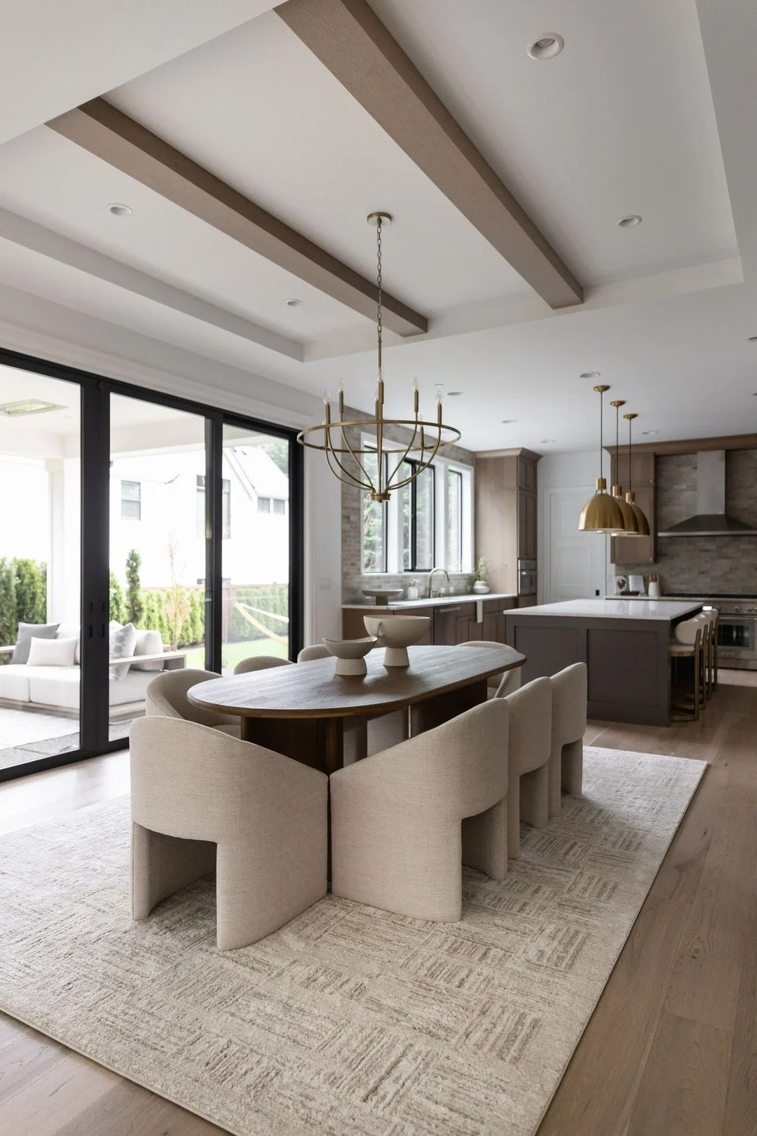 In this open-concept space, where the dining area sits between the kitchen and living room, we wanted it to feel distinct without competing with either side.

An oval dining table was chosen to contrast the rectangular kitchen island, bringing in a s