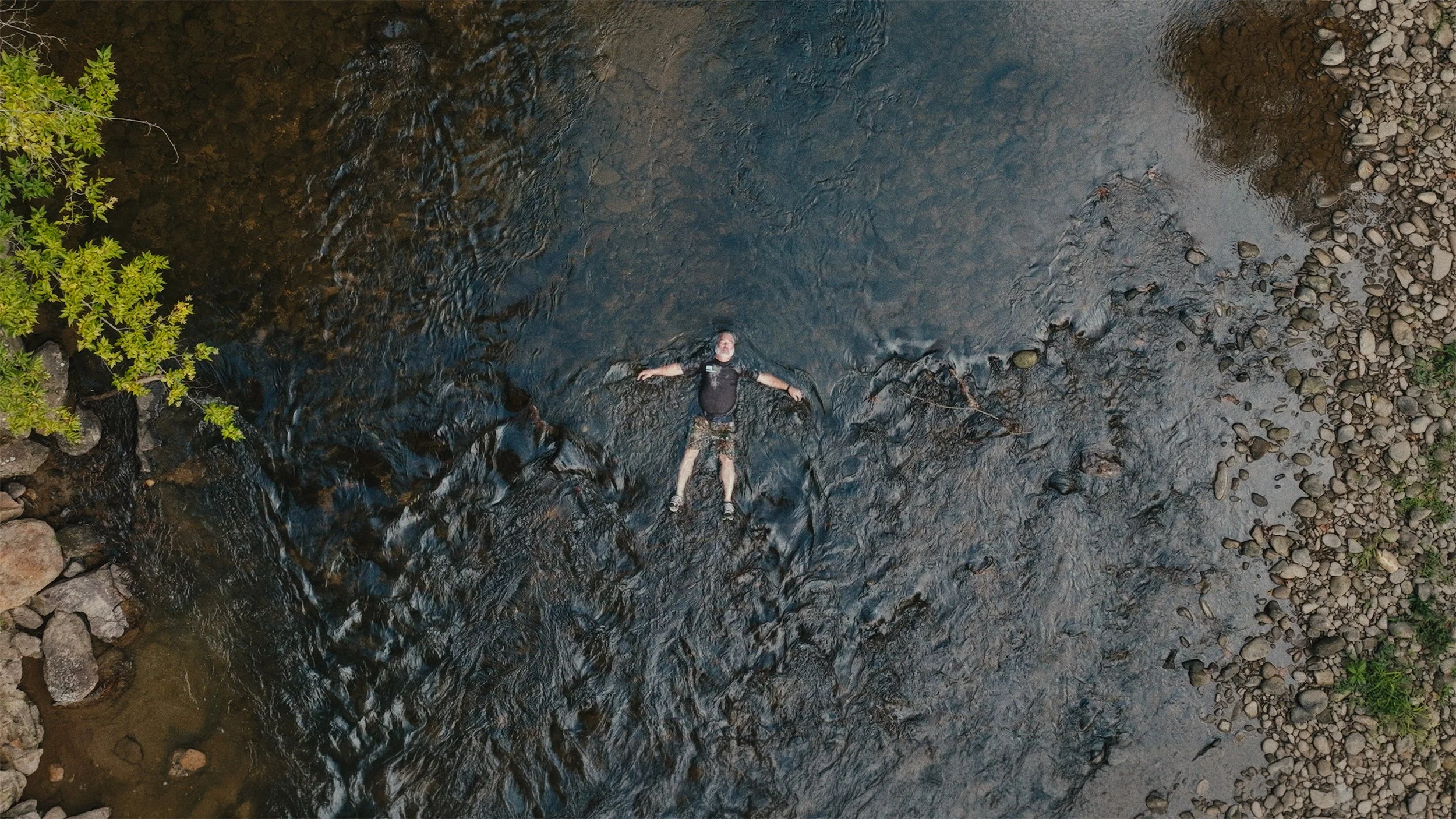 Mill employee Roger Frady in the Pigeon River.jpg