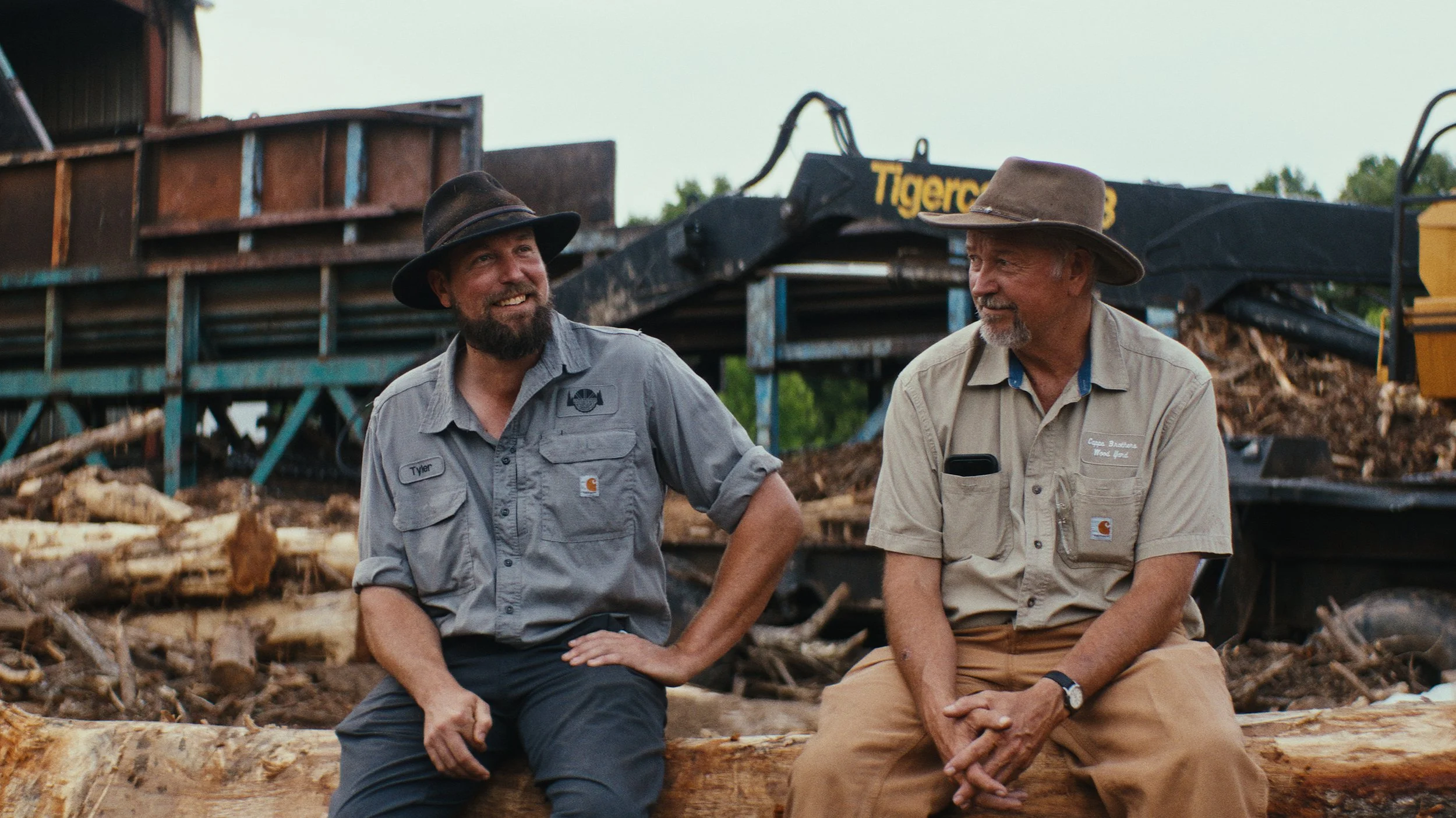 Capps Brothers sitting in front of their wood pulp business.jpg