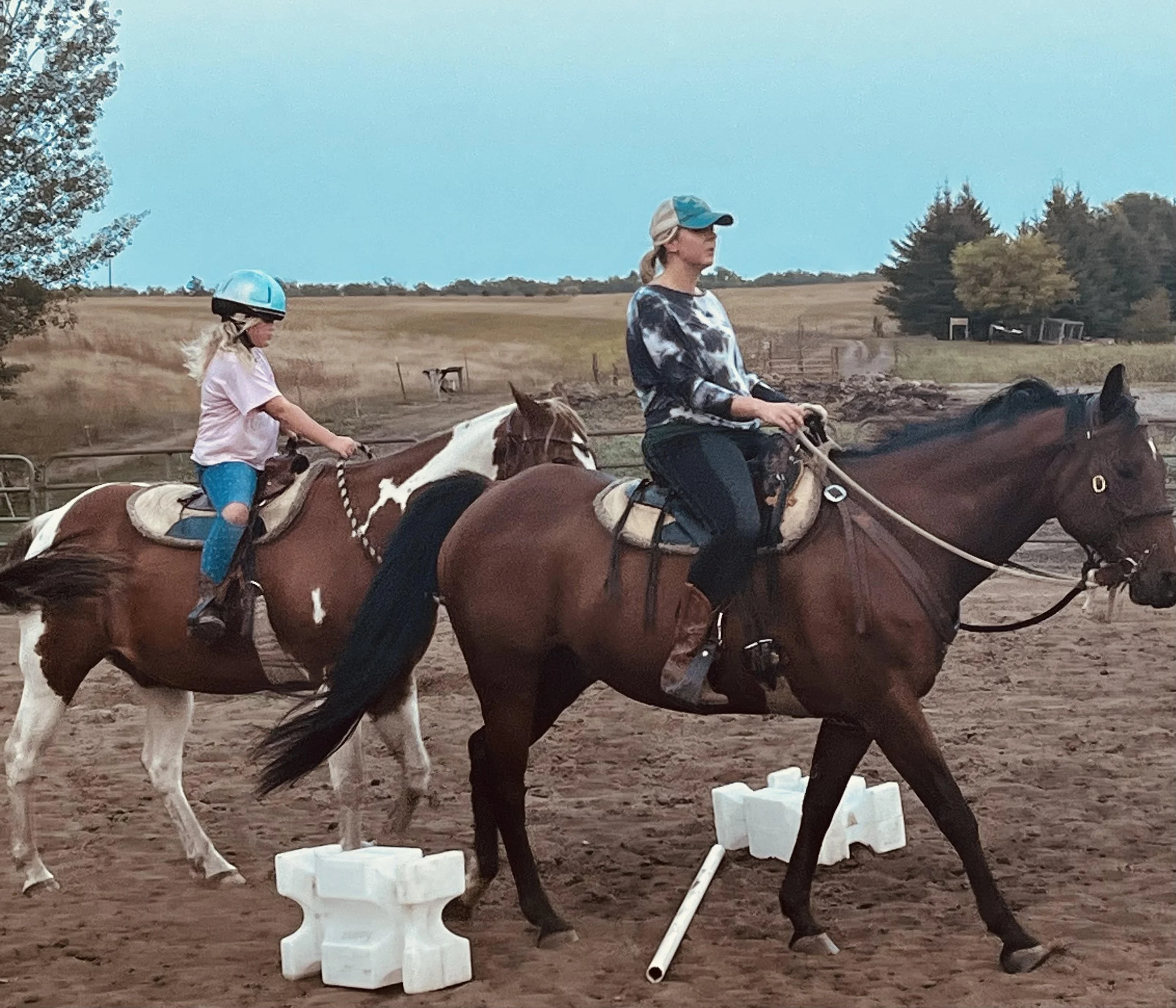 Mother and daughter riding horse