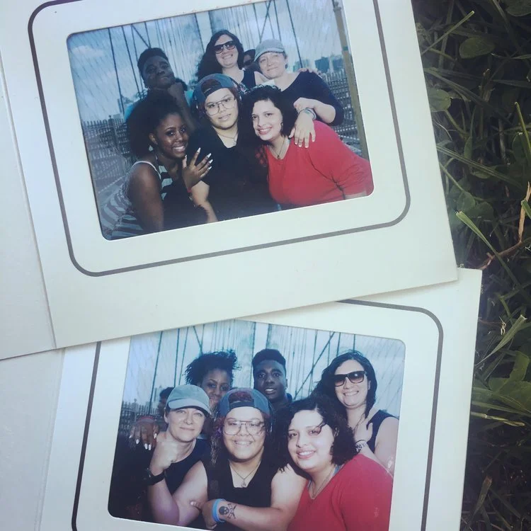 Two photo frames featuring groups of six friends each, smiling and posing outdoors with a background of a city skyline and a railing.