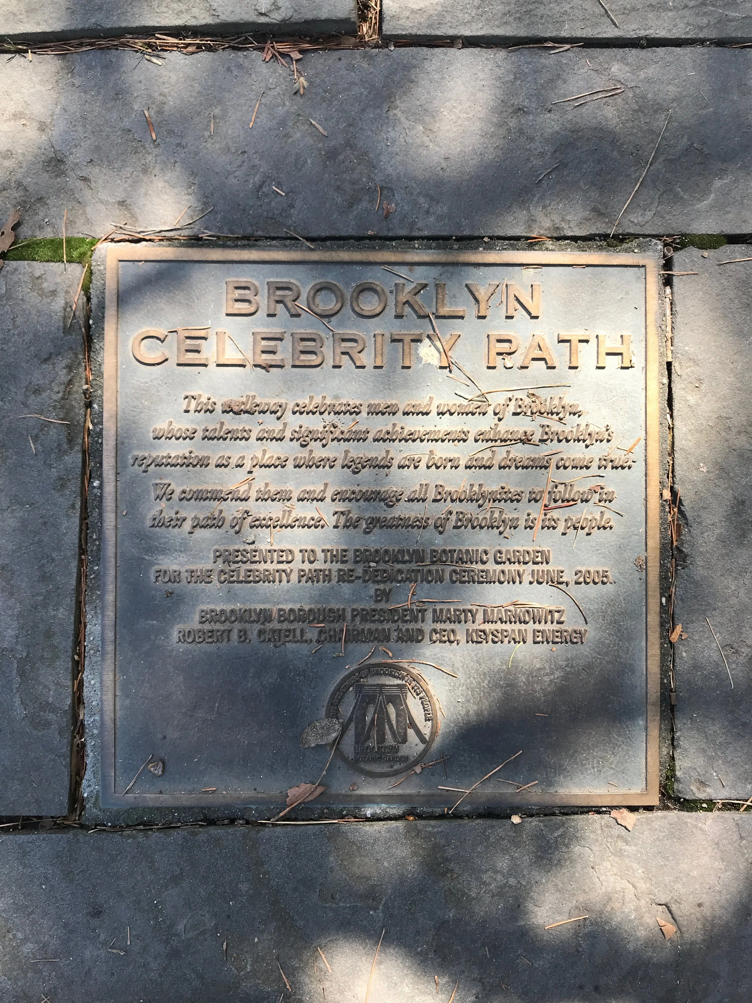A metal plaque on the sidewalk commemorates the Brooklyn Celebrity Path, dedicated in June 2005 by Brooklyn President Marty Markowitz and CEO of KeySpan Energy.