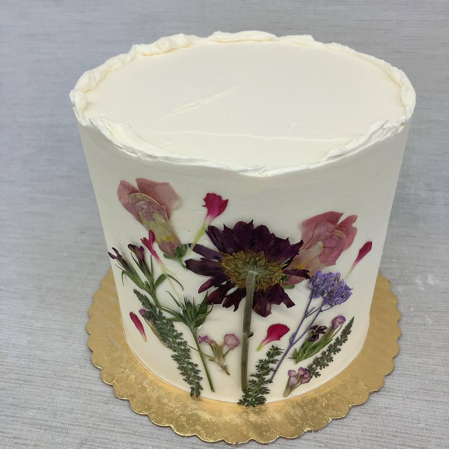 Freshly pressed spring flowers for this 6&rdquo; buttercream cake! Order online: https://www.sweetandshiny.com/shop/p/layered-letter-cake-8m93j