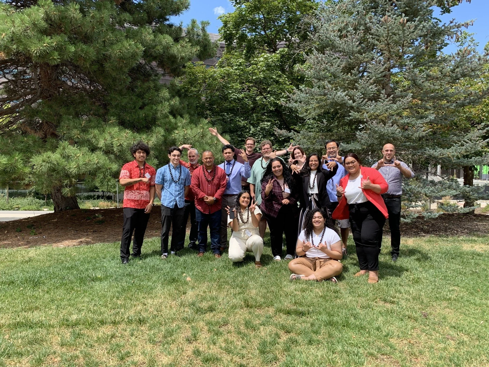 lab members and mentors standing outside smiling together.