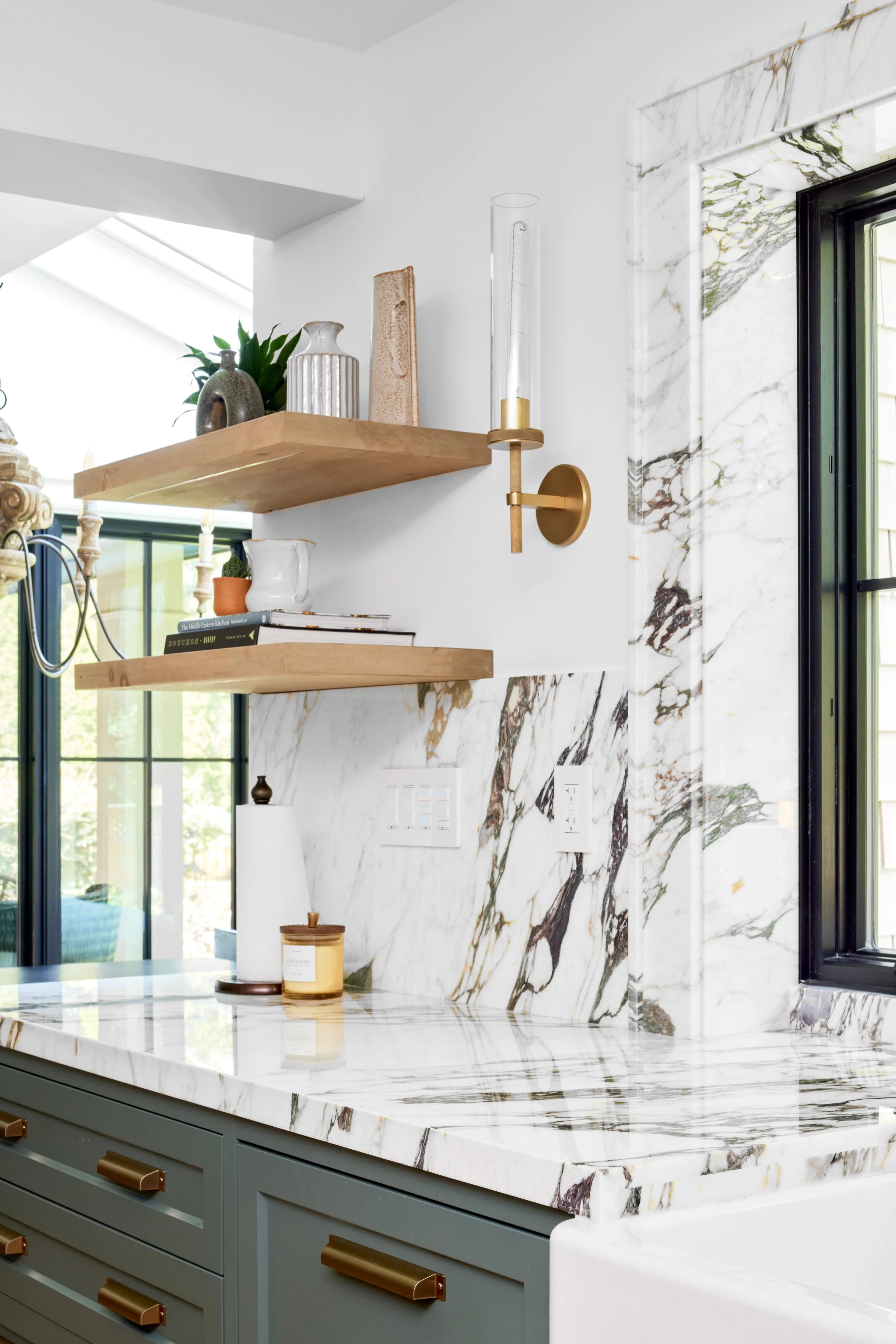 High-end custom modern kitchen in Mississauga, Oakville and Toronto, Ontario. Features trends color for 2024, luxurious gold hardware, and a marble countertop. Serving millwork and cabinetry accross GTA. 