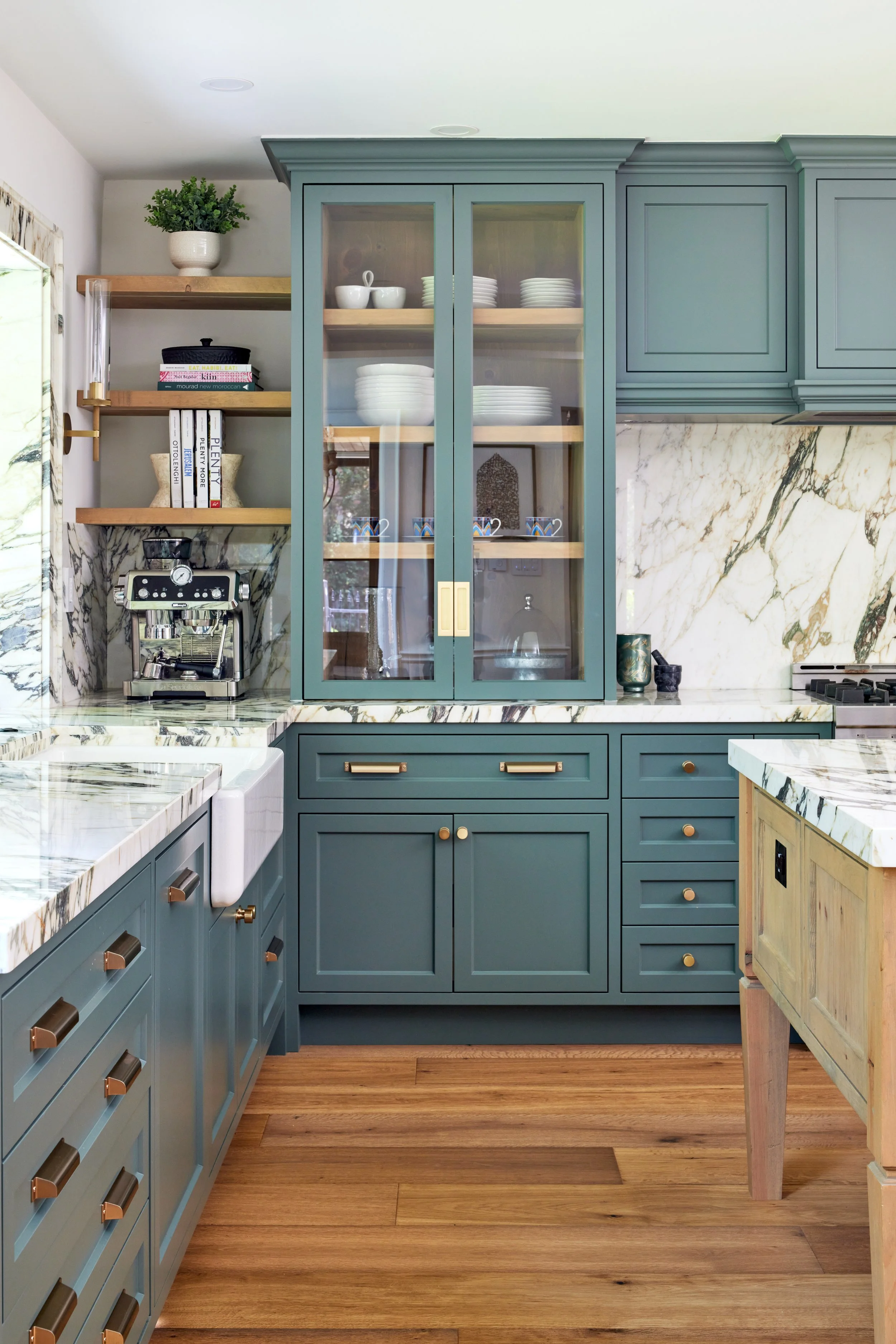 
High-end custom modern kitchen in Mississauga, Oakville, and Toronto, Ontario. Features trends color for 2024, luxurious gold hardware, a marble countertop, and an elegant kitchen sink. Serving millwork and cabinetry across the GTA.