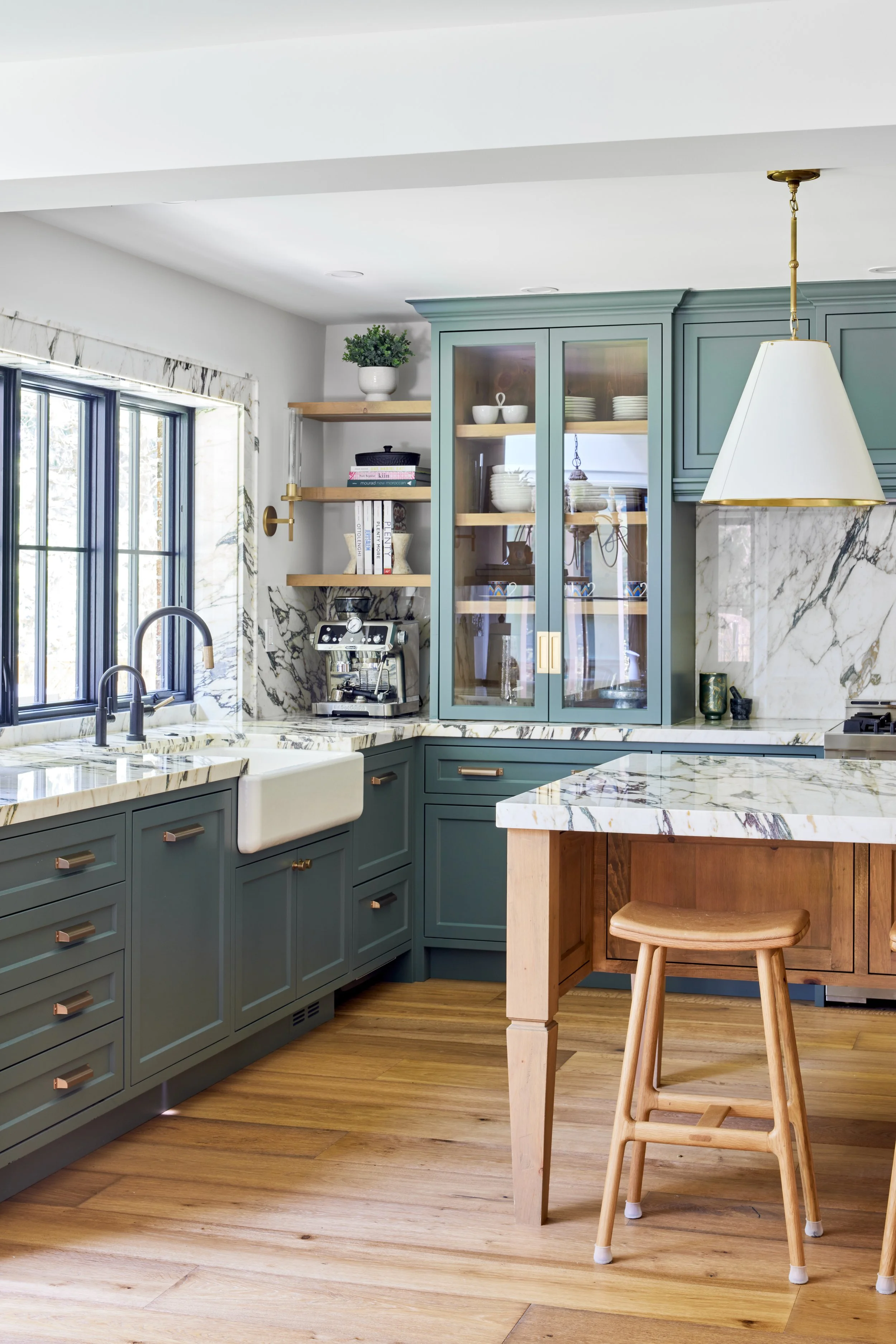 High-end custom modern kitchen in Mississauga, Oakville and Toronto, Ontario. Features trends color for 2024, luxurious gold hardware, and a marble countertop. Serving millwork and cabinetry accross GTA. 