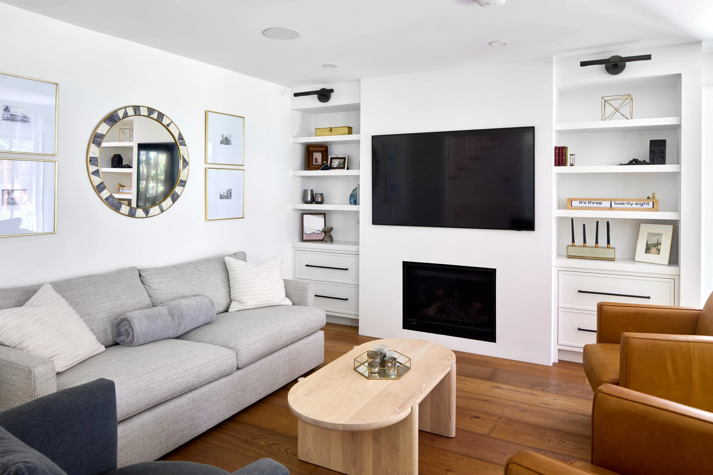 Monochrome custom shelf TV unit, clean and modern cabinets, cabinets with black matte handle, living room and interior renovations Oakville Mississauga and Toronto, serving custom cabinetry and renovation accross Greater Toronto Area.
