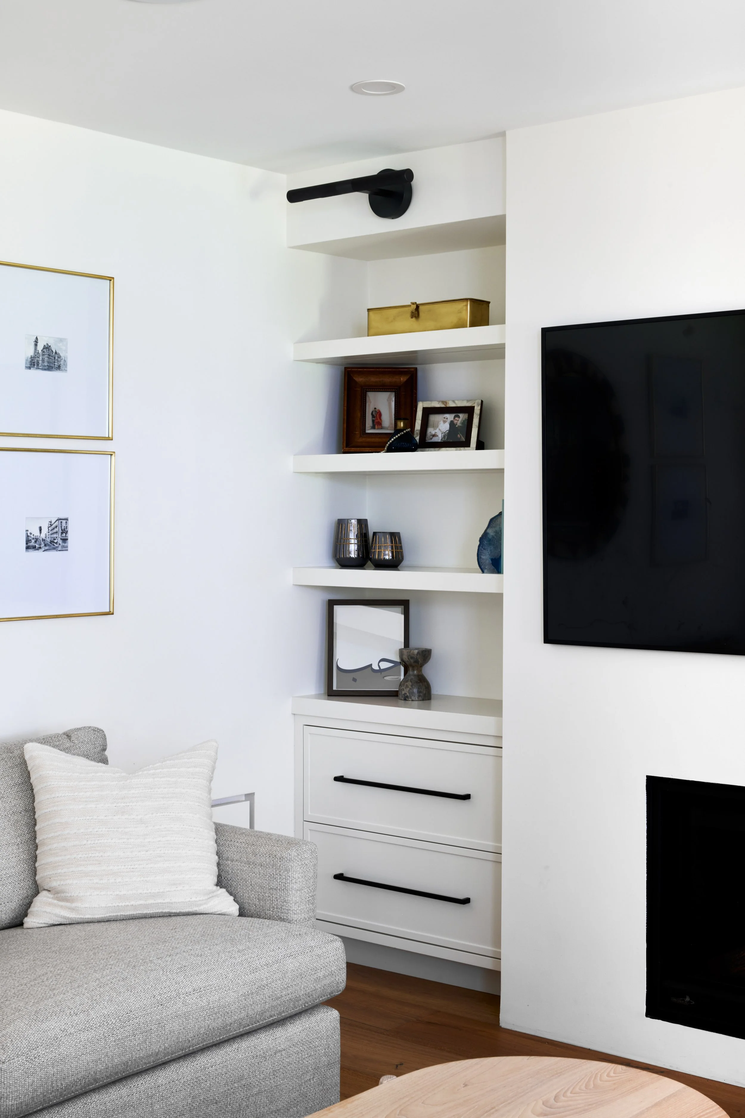 Monochrome custom shelf TV unit, clean and modern cabinets, cabinets with black matte handle, living room and interior renovations Oakville Mississauga and Toronto, serving custom cabinetry and renovation accross Greater Toronto Area.
