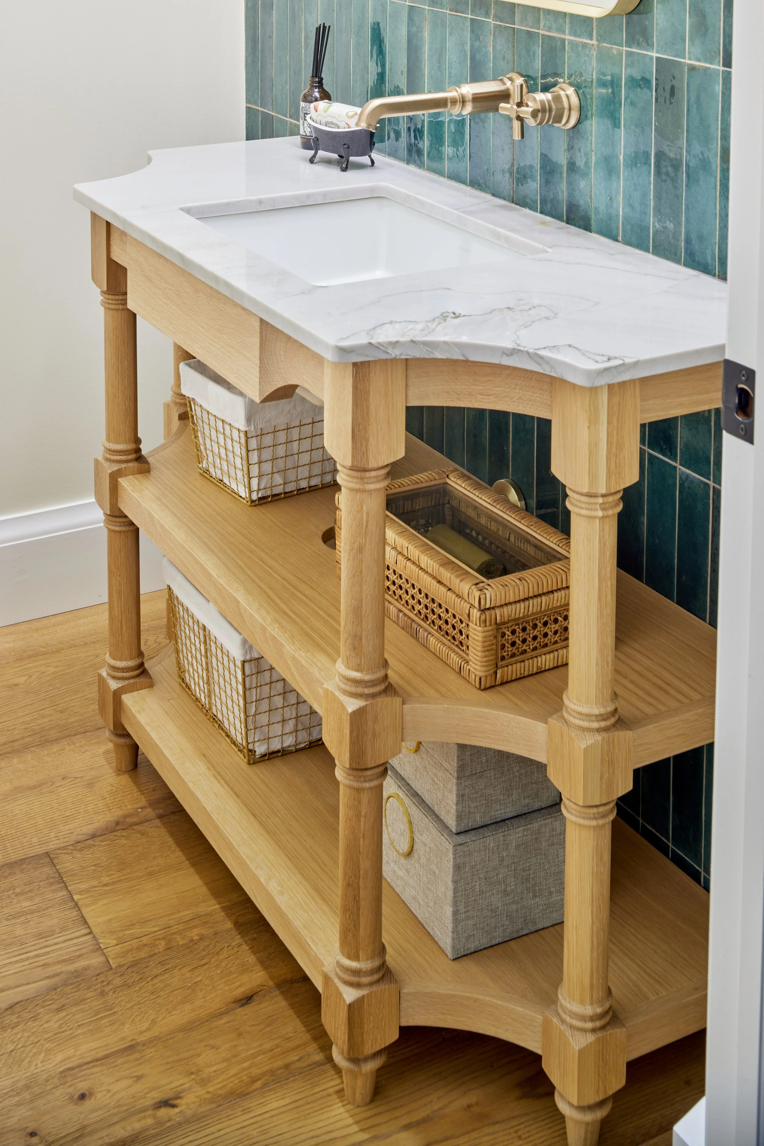 Kitchen and bath renovation trends. features white marble, brass faucet and gorgeous green tile. Custom bathroom vanity serving kitchen and bath renovations Greater Toronto Area including Mississauga, Oakville, ideal for those seeking tailored cabine