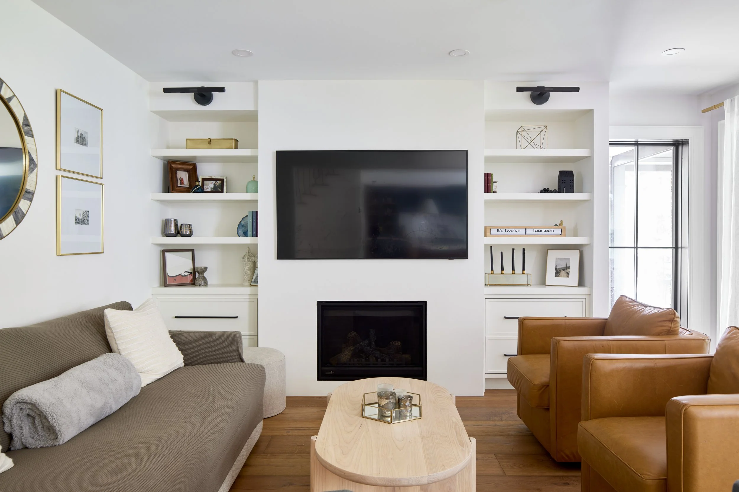 Monochrome custom shelf TV unit, clean and modern cabinets, cabinets with black matte handle, living room and interior renovations Oakville Mississauga and Toronto, serving custom cabinetry and renovation accross Greater Toronto Area.
