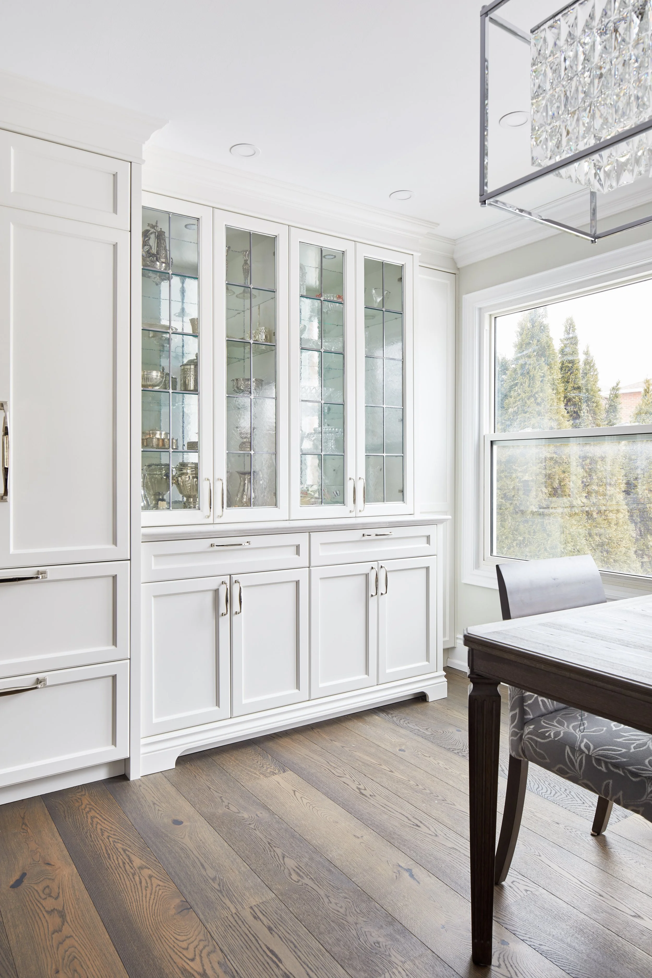 At Seif Designs, we offer top-quality kitchen renovation services around the GTA, Mississauga, Oakville. This traditional kitchen showcases custom white cabinetry with classic detailing and a bold blue island as the focal point. The island features i