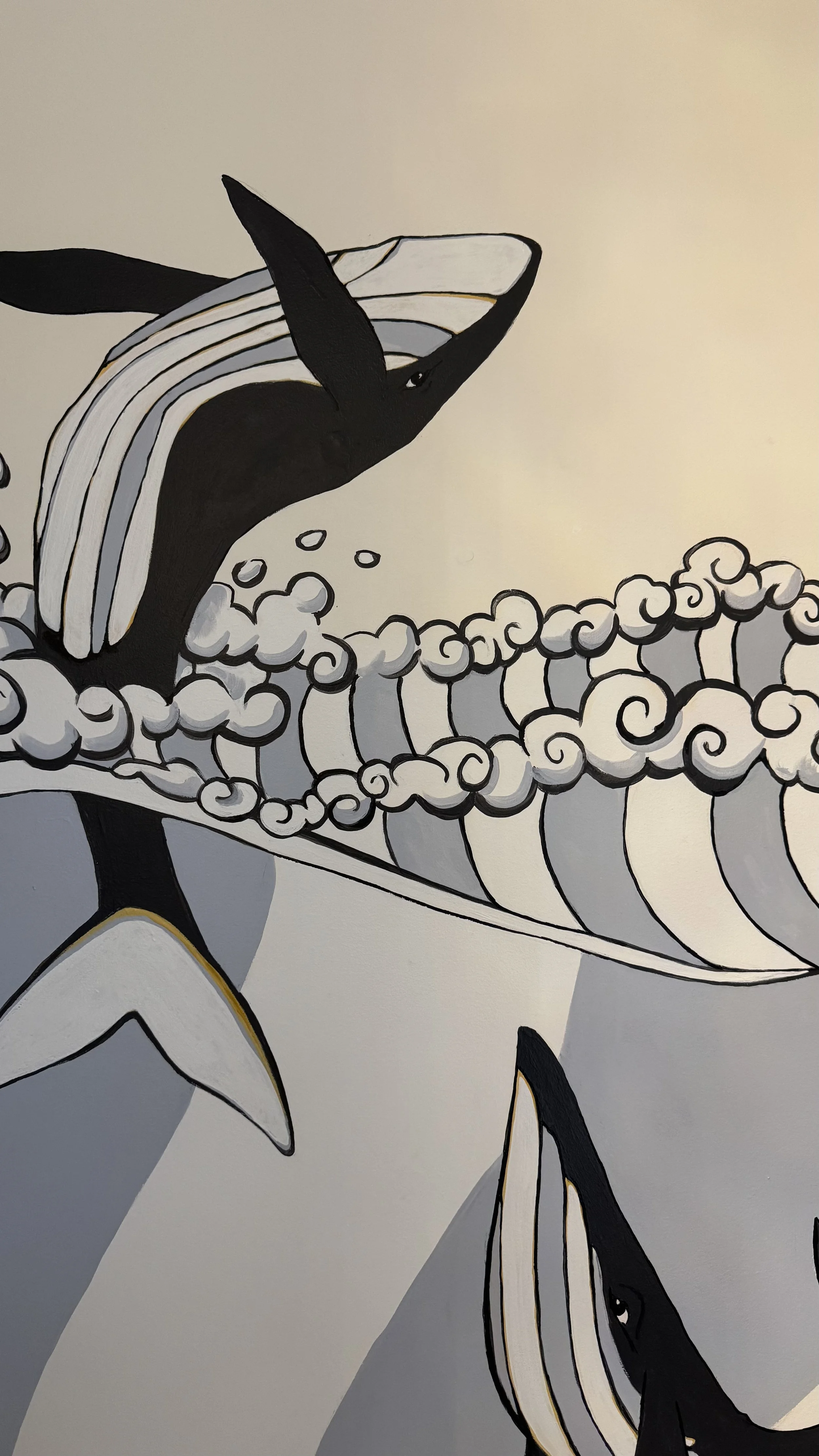 A black and white illustration of orcas, with one whale breaching through stylized waves.