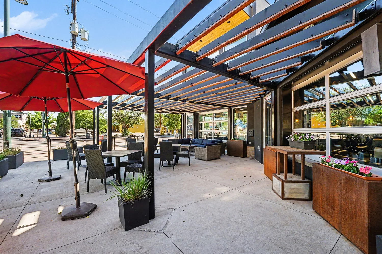 Restaurant patio with pergola and red umbrellas