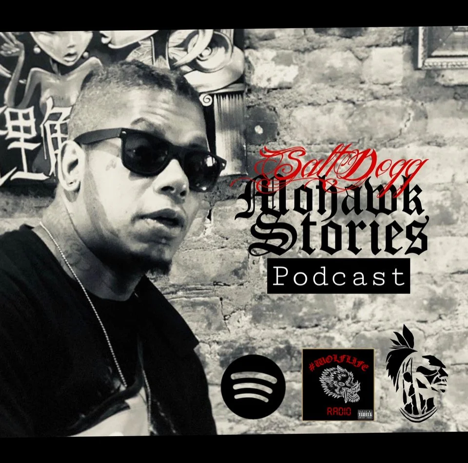 A young man wearing sunglasses and a black shirt takes a selfie against a brick wall. Overlaid text reads "SaltDogg Homicide Stories Podcast" with icons for Spotify, a radio station, and a graphic logo