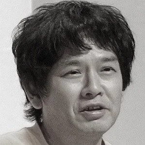 Black and white photo of a man with medium-length hair, facing forward.