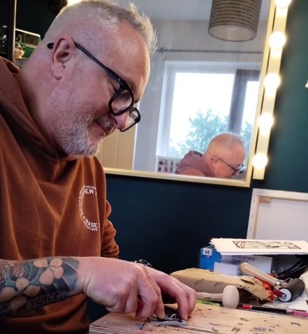 Paul Beesley at work in his studio creating a linocut print