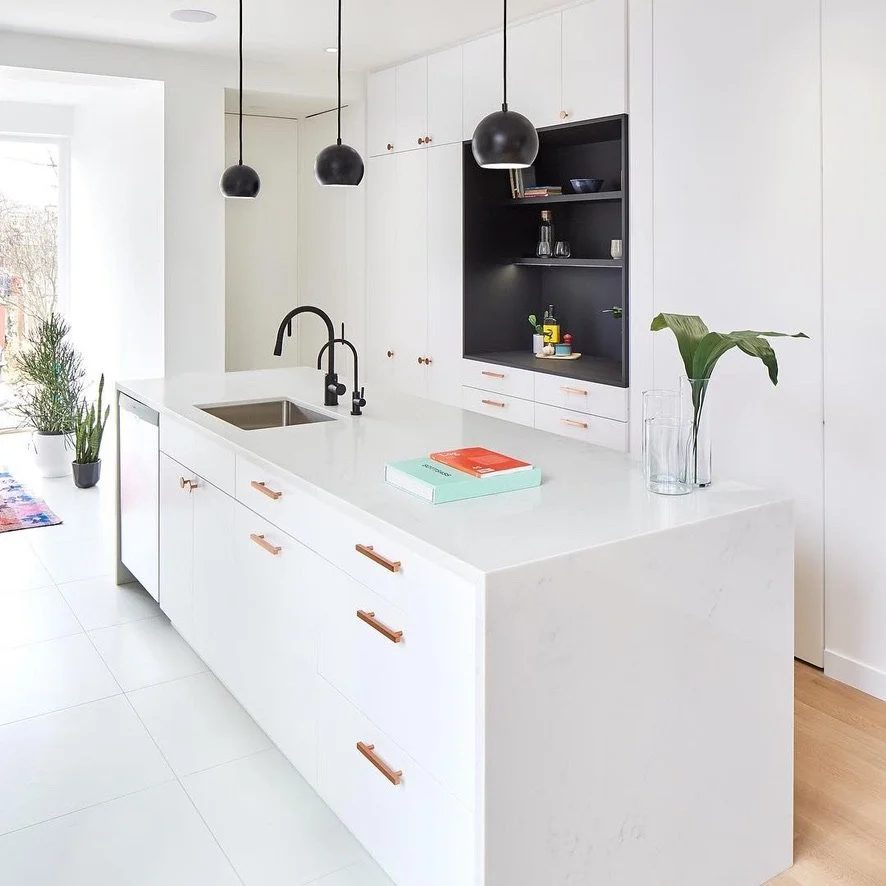 custom cabinetry island with a waterfall quartz countertop