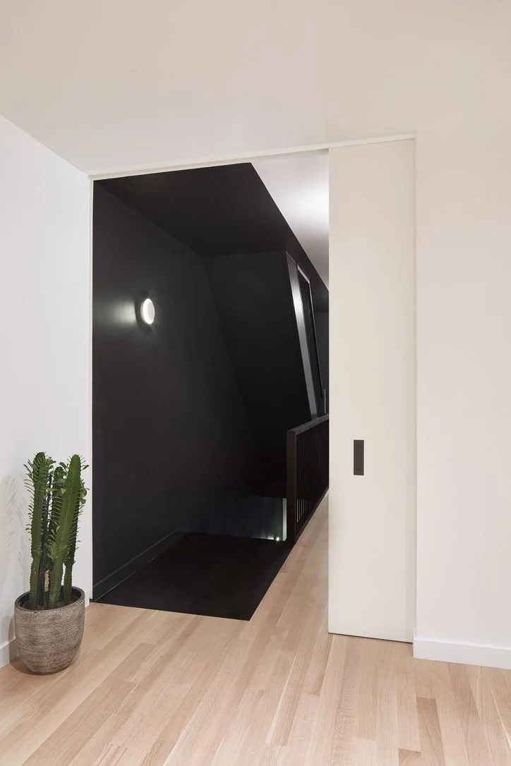 two tone flooring with a custom eight foot pocket door