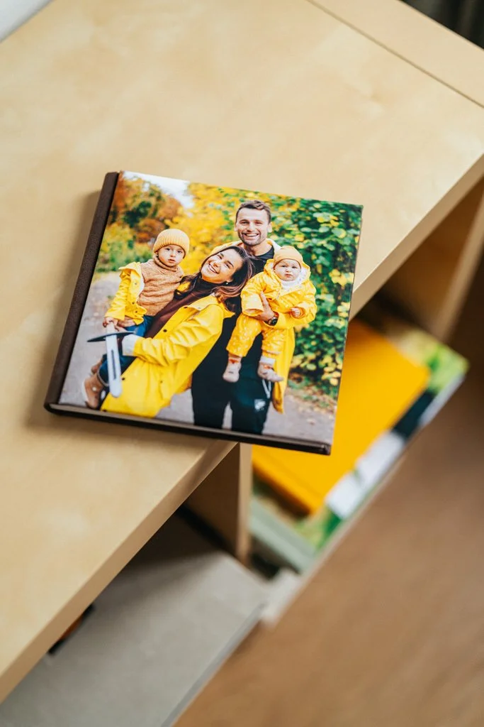 Photo album with family picture on cover, on wooden shelf