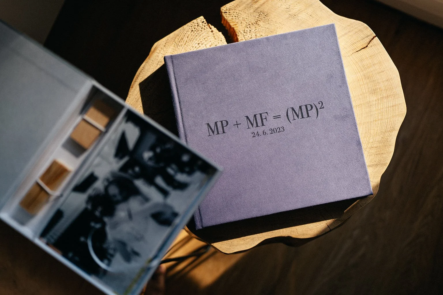 Close-up of a purple book on a wooden table with mathematical equation and date on cover