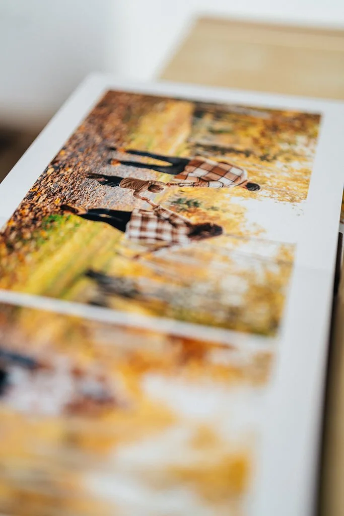 Photo album page with a photograph of three people walking hand in hand through an autumn park, wearing plaid shirts.