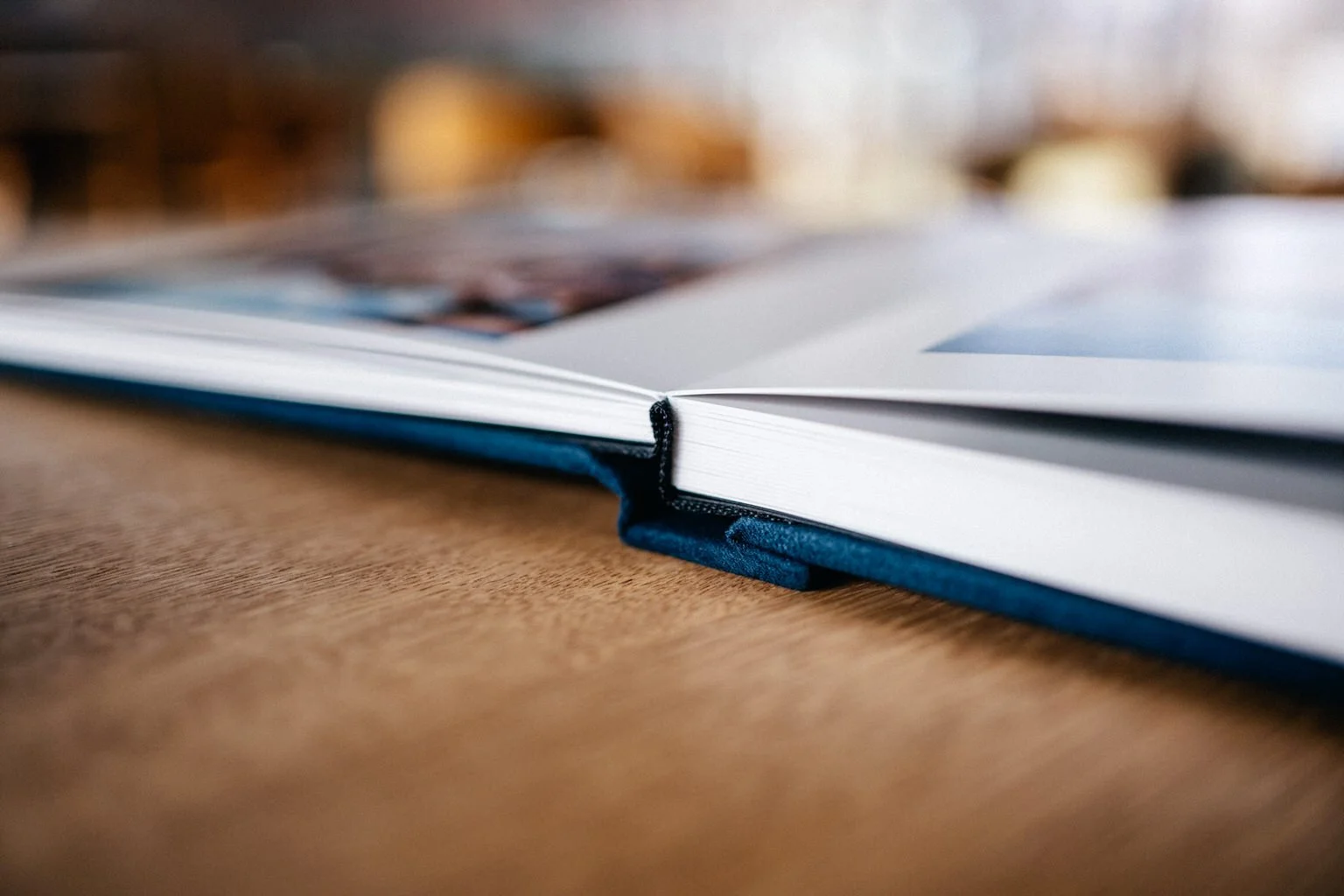 Close-up of an open book on a wooden surface
