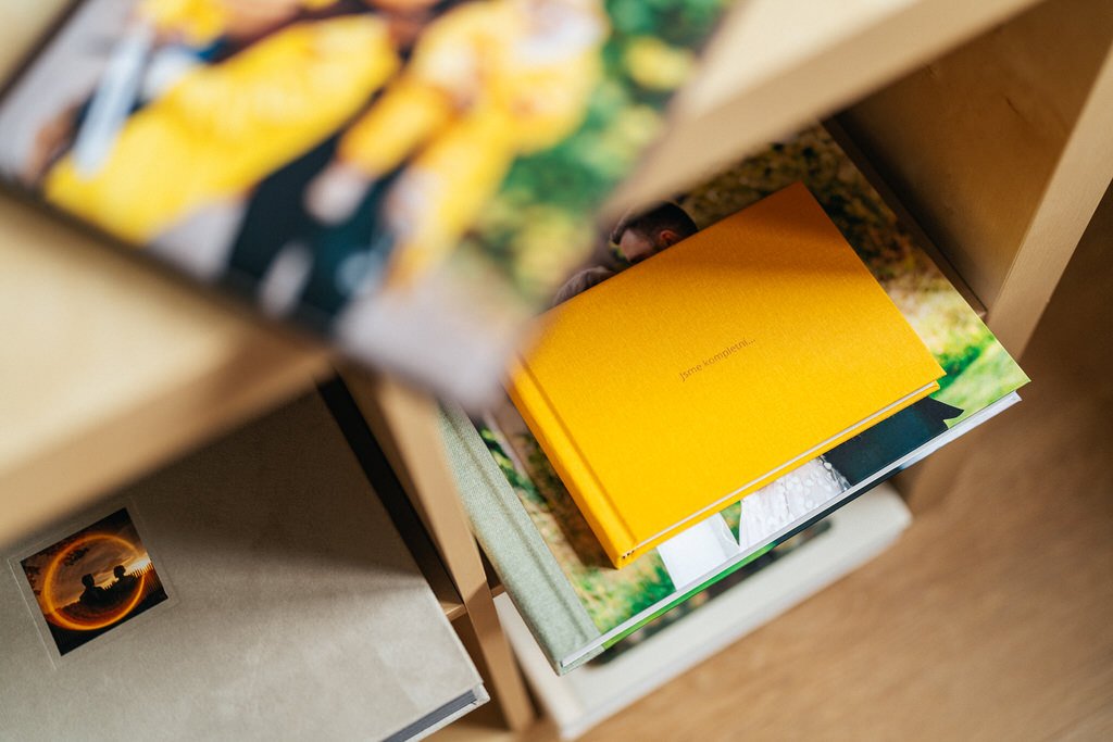 Yellow book and photo albums on a wooden shelf