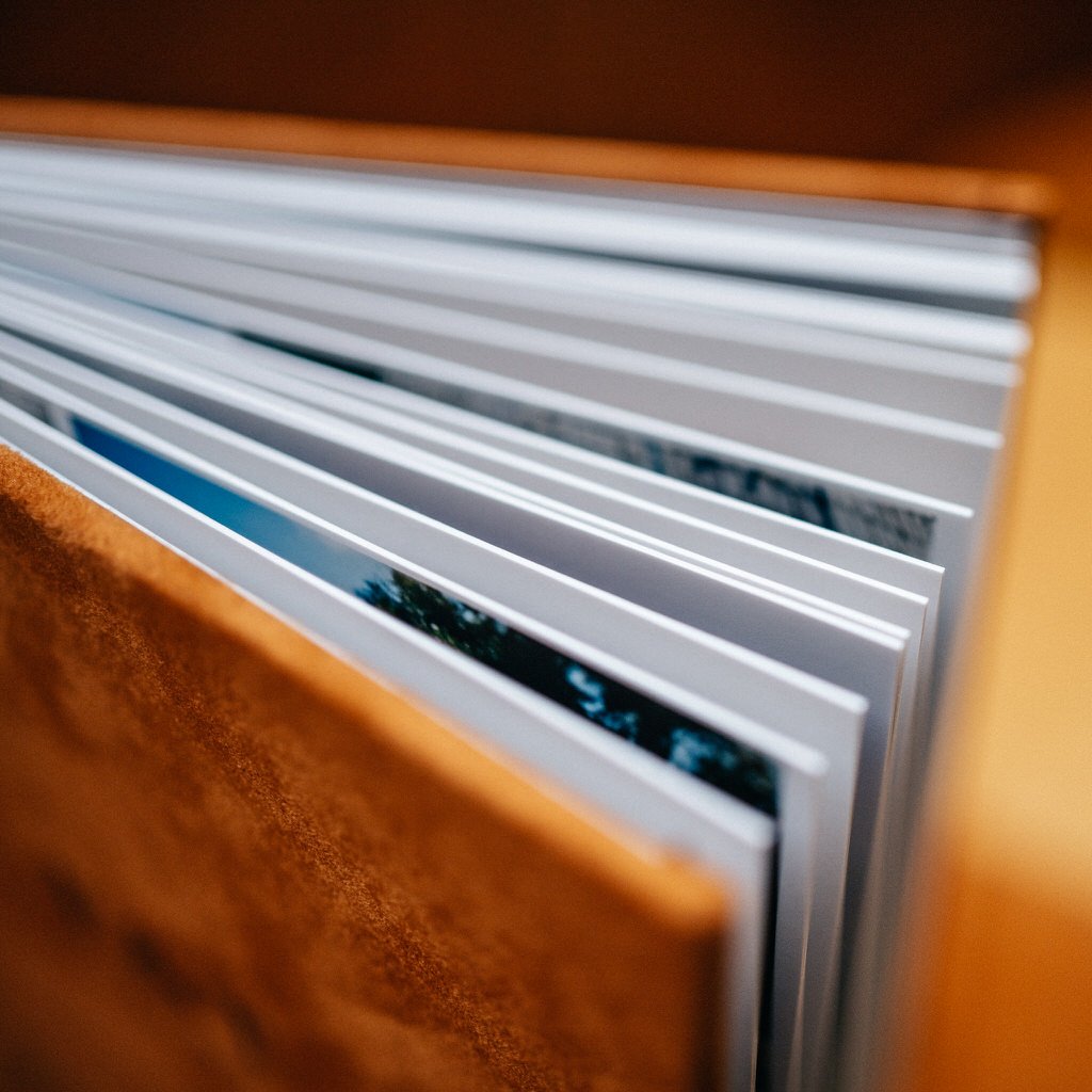 Close-up of an open photo album with thick pages and a textured cover.