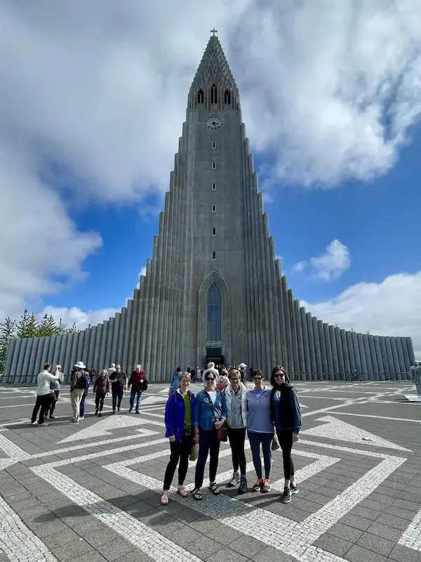 small group standing in front of iceland church in reykjavik