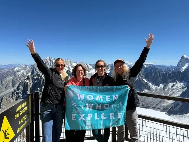 group of 4 women over a glacier and mountains in the alps