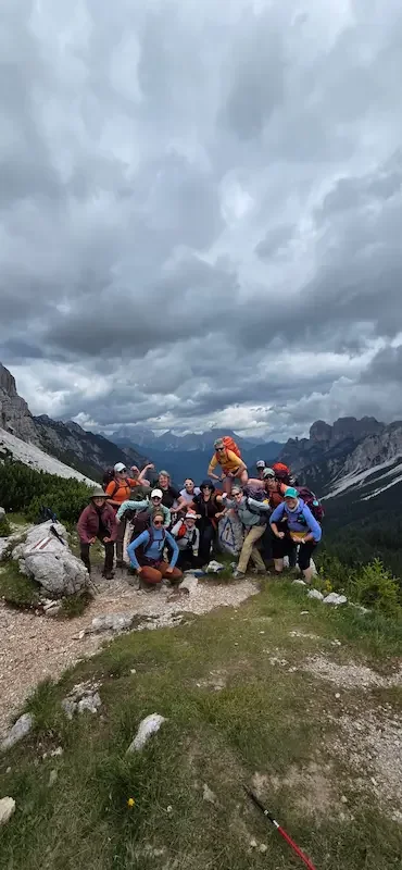 group of women posing with strong arms in dolomites valley