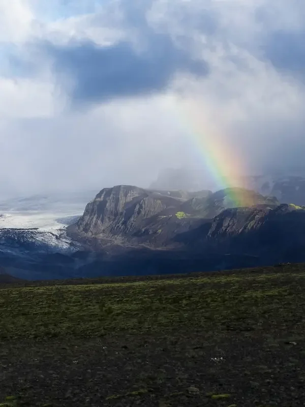 mountain in iceland with clouds and rainbow
