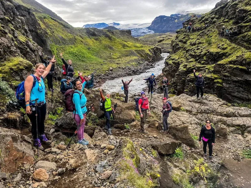 group of women in small canyon on laugavegur trek in iceland with low clouds and river in background
