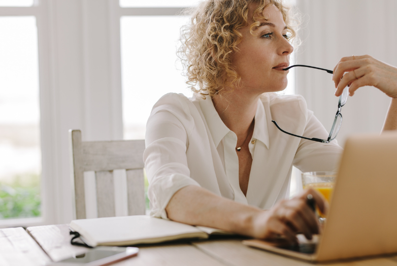 Professional woman reviewing financial information while considering whether to keep or sell a Los Angeles rental property.