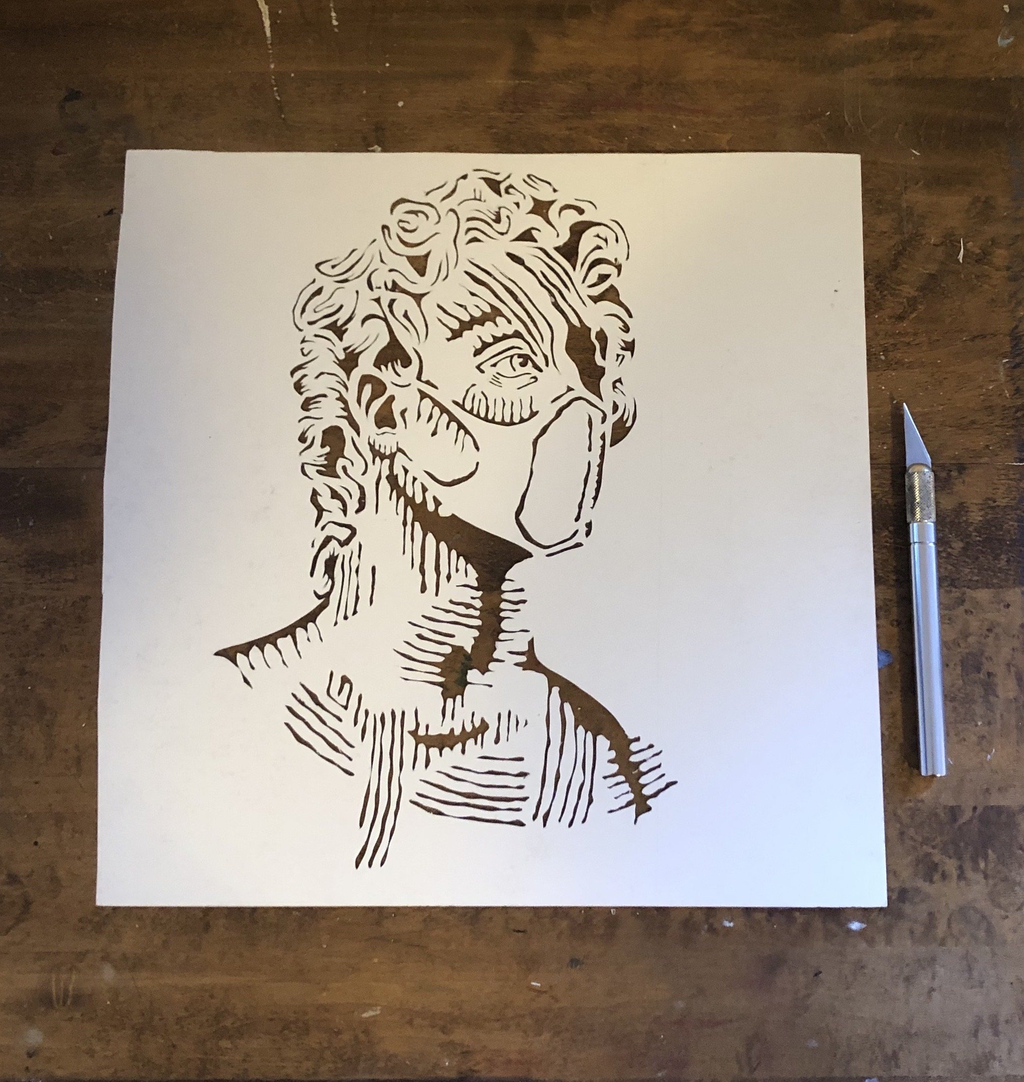 Stencil for the "Masked Up" painting. Exacto knife and poster paper.