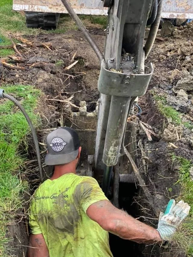 A member of the Drain Guys Chicago team doing a traditional sewer repair.