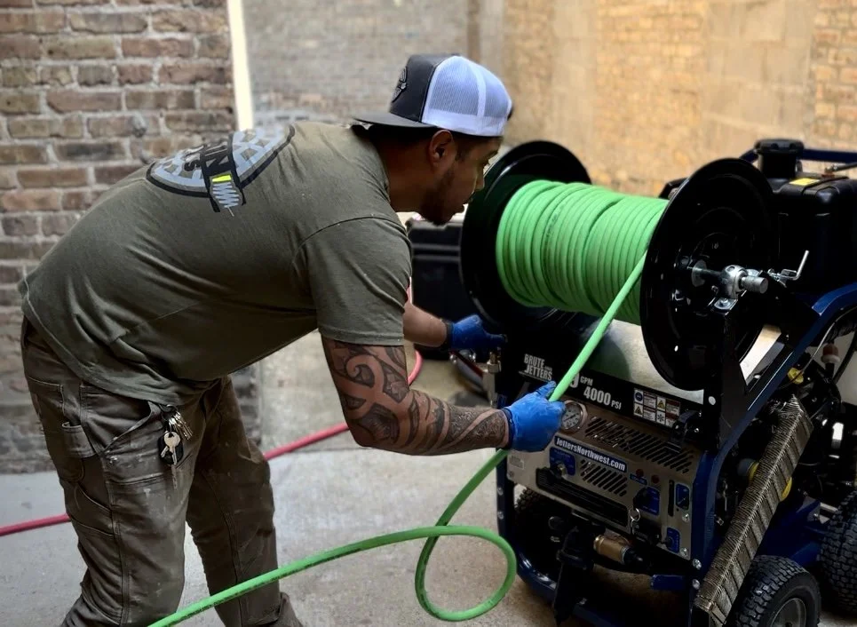 Felix from Drain Guys Chicago hydro-jetting a sewer/drain line.