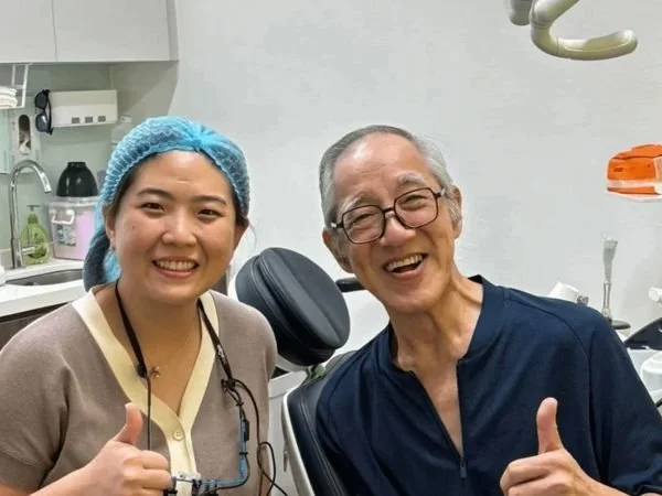 Smileplus Dental dentist and older male patient smiling and giving thumbs up together in a dental treatment room