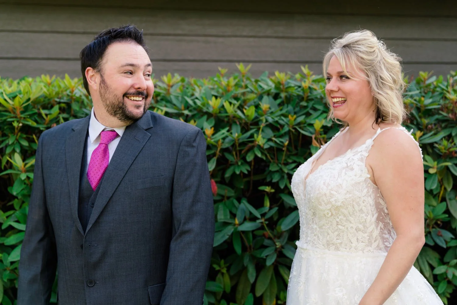 Bride and groom laughing during joyful first look portrait at intimate backyard wedding in Vancouver WA.