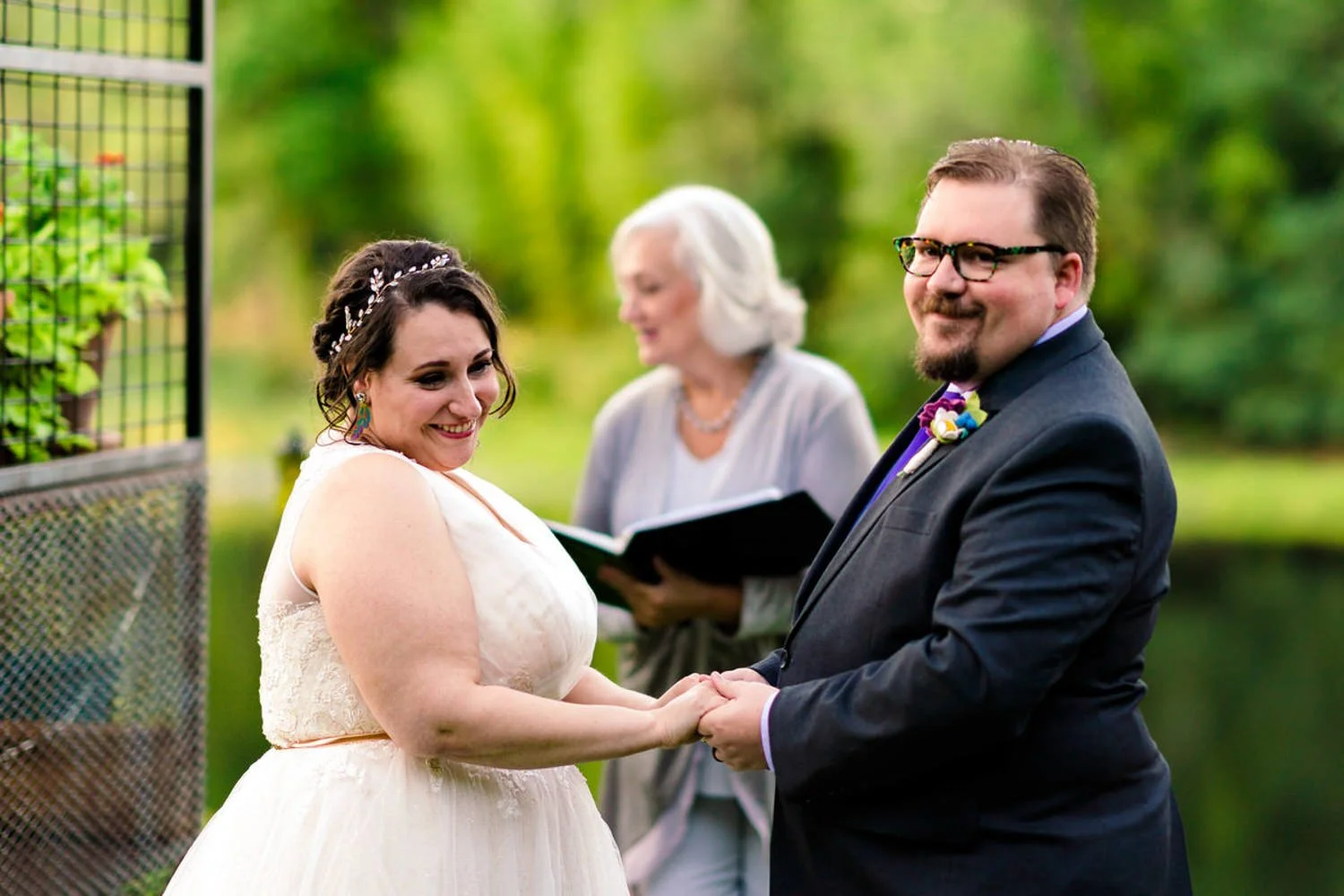 Couple holding hands and smiling during a simple backyard elopement in Clackamas, Oregon.