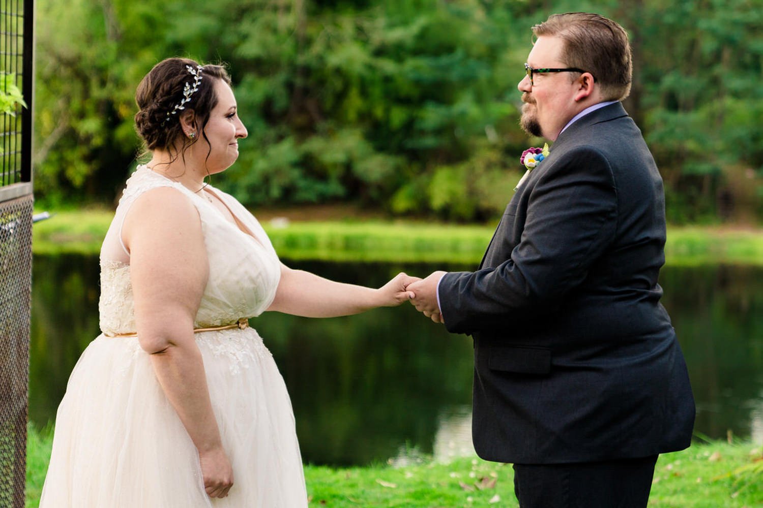Couple holding hands during a simple elopement by the Clackamas River in Oregon.