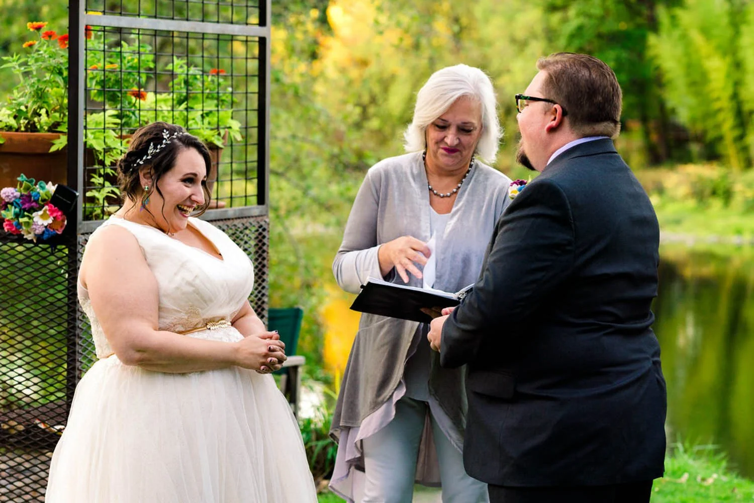Officiant reviewing paperwork with the couple during a simple backyard elopement in Clackamas, Oregon.