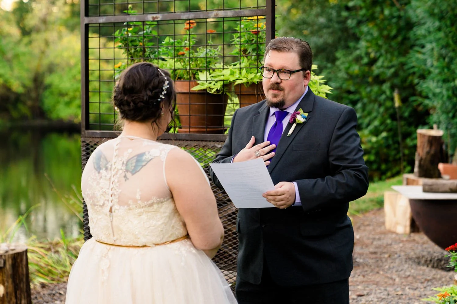 Intimate elopement ceremony in Clackamas, Oregon with the groom sharing vows in a private backyard setting.