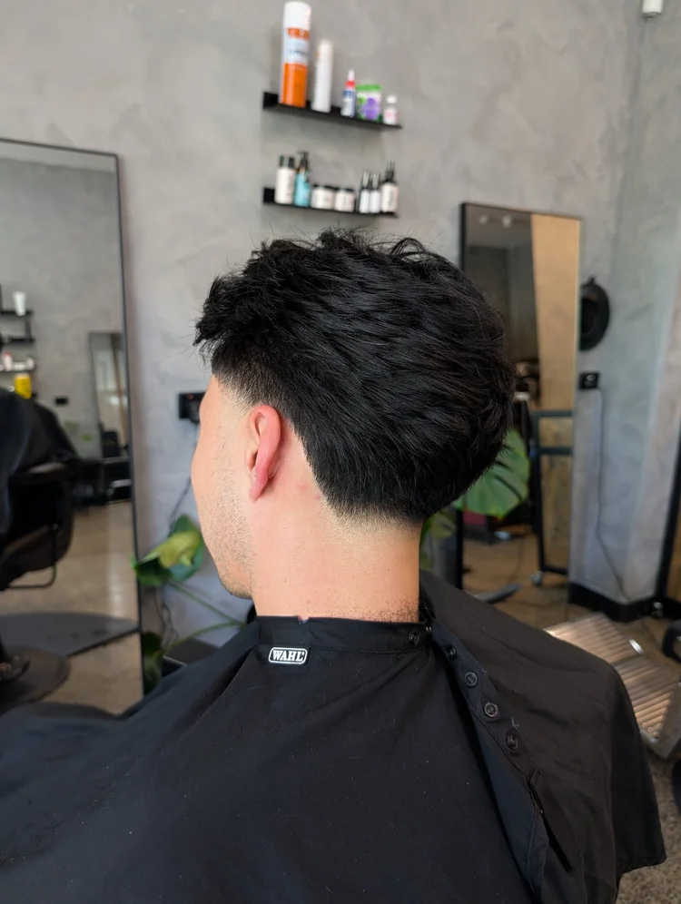 Back view of a low taper fade with textured top