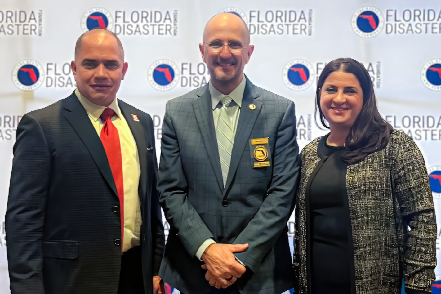 ESR team members standing with FDEM Executive Director Kevin Guthrie at the 6th Annual Emergency Management Day.