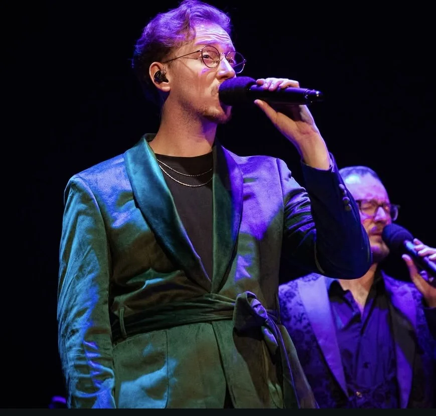 Owen performing onstage with The Swingles