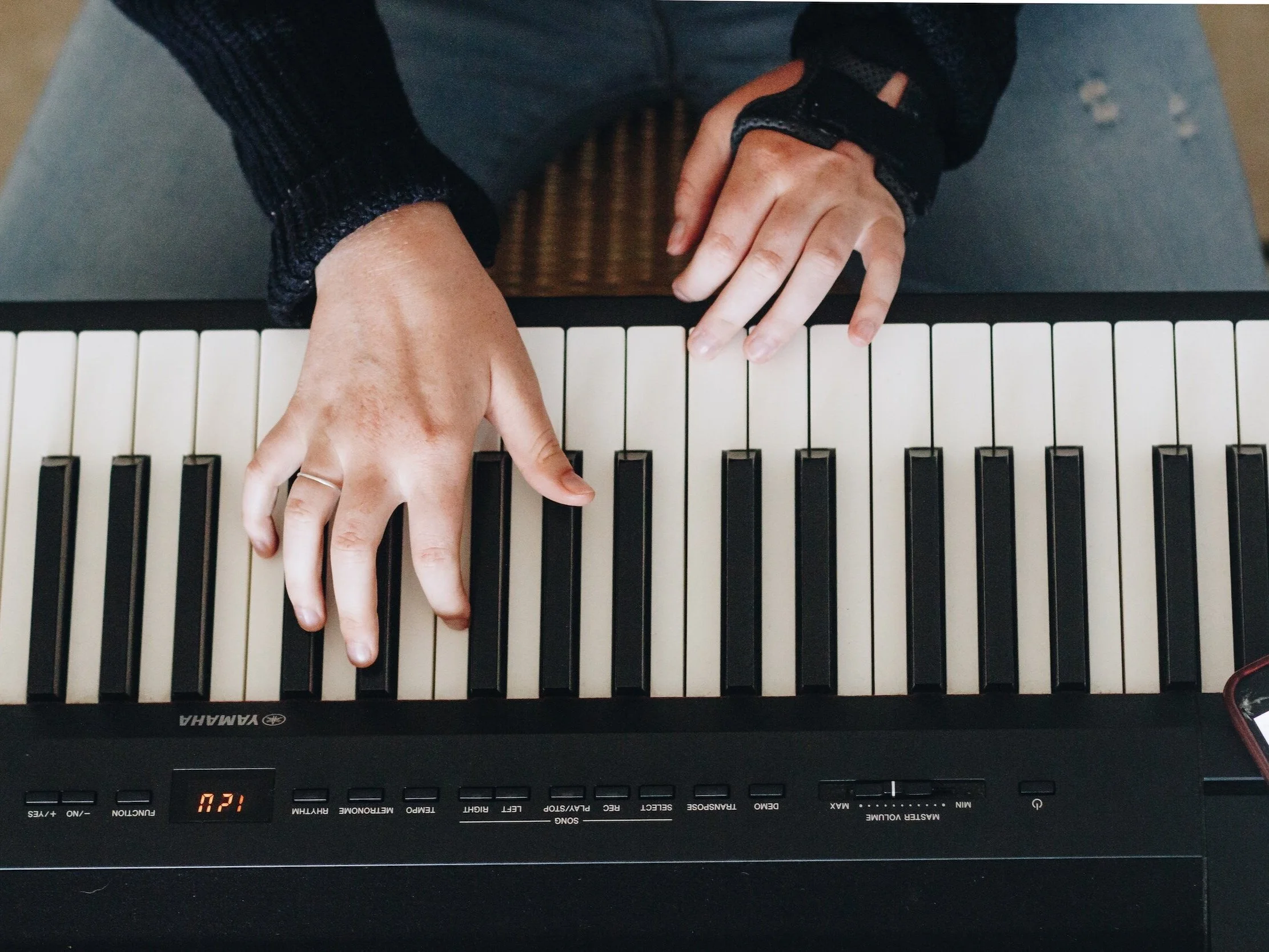 Singing Teaching - an image of hands playing a piano in a singing lesson